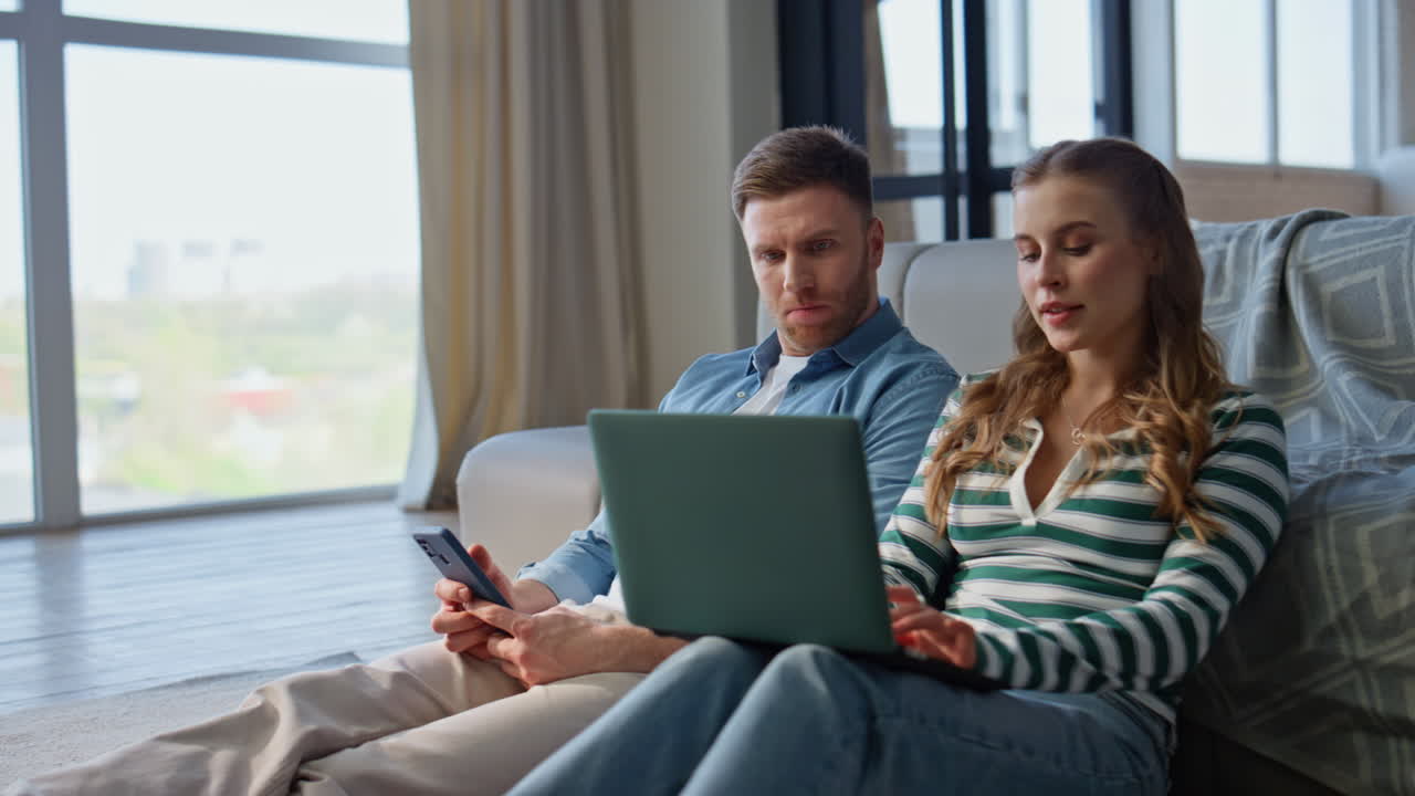 Pair sitting home gadgets at weekend morning closeup. Carefree family leisure