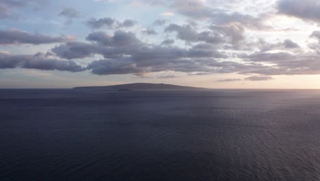 Super-wide-aerial-dolly-shot-of-Molokini-Crater-and-the-sacred-island-of-Kaho'olawe-at-sunset-from-Wailea-on-the-island-of-Maui,-Hawai'i