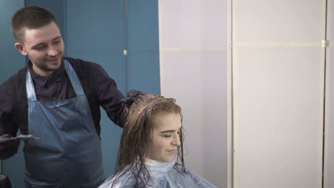 young woman and hairdresser making styling hair at beaty salon