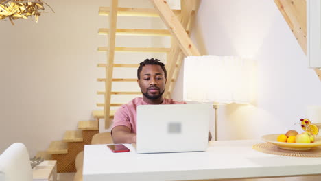 man working on laptop at home