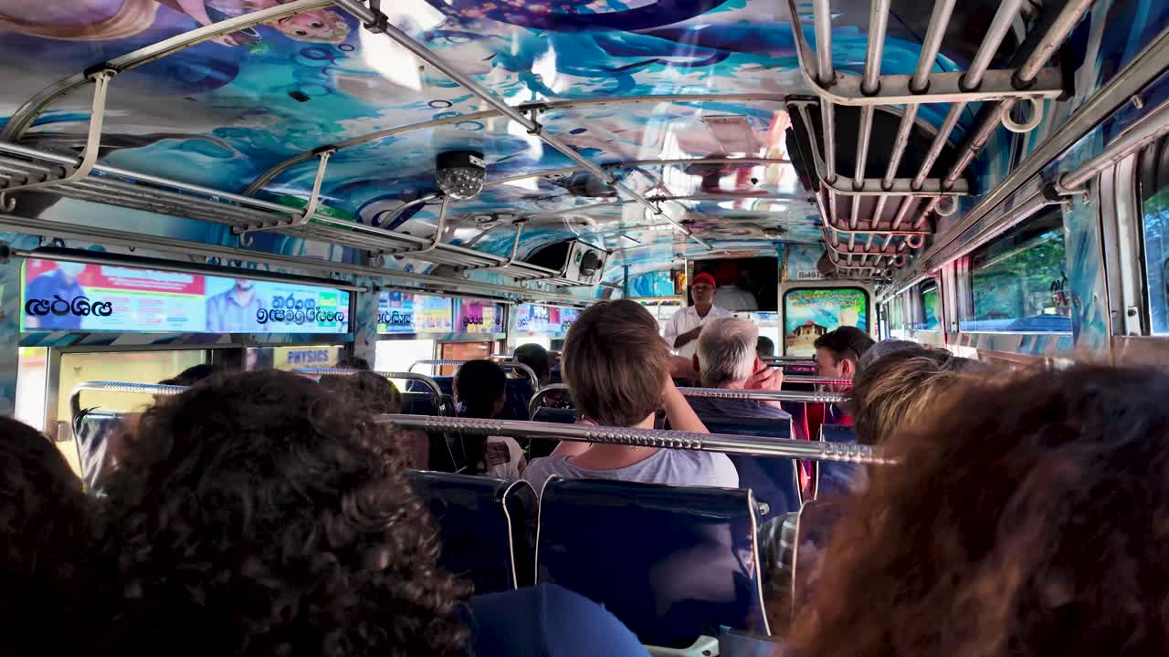 Experience the lively atmosphere inside a vibrant Sri Lankan bus. The colorful interior and diverse passengers create a dynamic and cultural traveling experience.