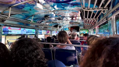 experience the lively atmosphere inside a vibrant sri lankan bus. the colorful interior and diverse passengers create a dynamic and cultural traveling experience.
