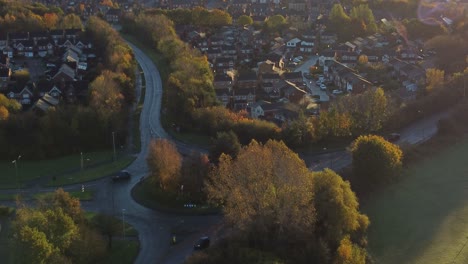 establishing aerial view early morning autumn sunrise over british residential neighbourhood to fiddlers ferry skyline