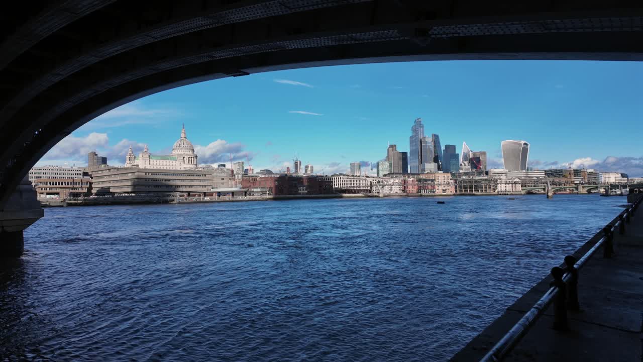 London skyline with St Paul’s Cathedral viewed under bridge over Thames