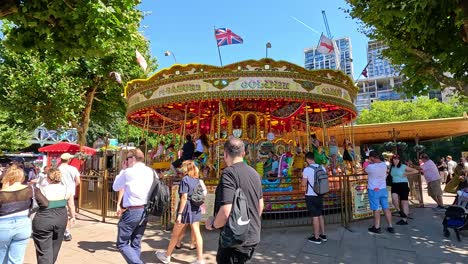 people enjoying a carousel ride in london