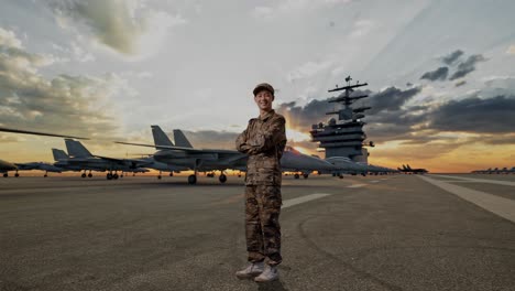 full body of side view of asian man soldier smiling and crossing his arms while standing on aircraft carrier