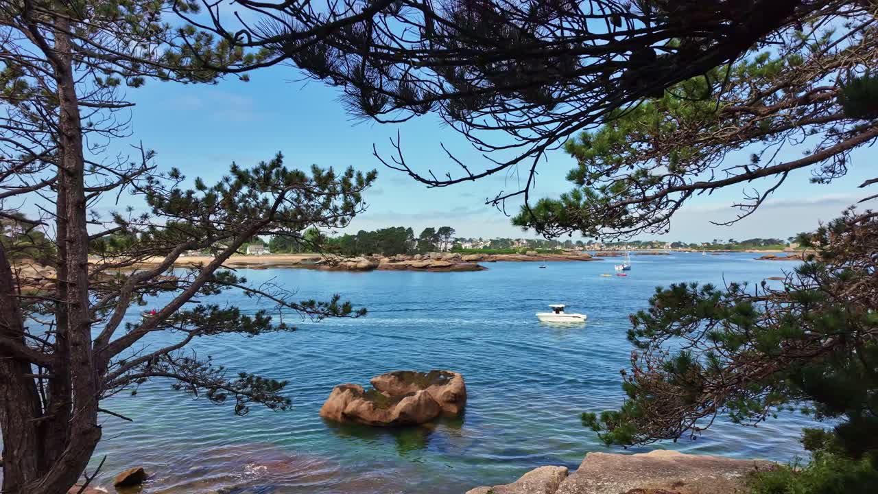 Coastal view of Trégastel with boats between pine forest, Côtes-d'Armor, Brittany, France