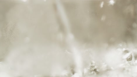 macro shot of hot water being poured in a glass in slow motion