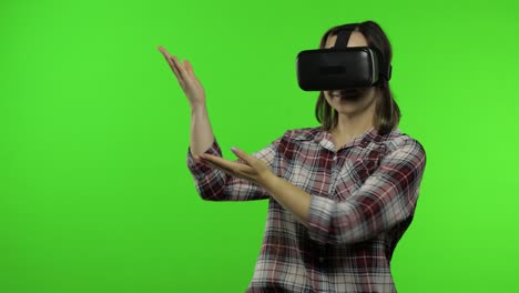 young woman using vr headset helmet to play game, showing side advertising area. chroma key