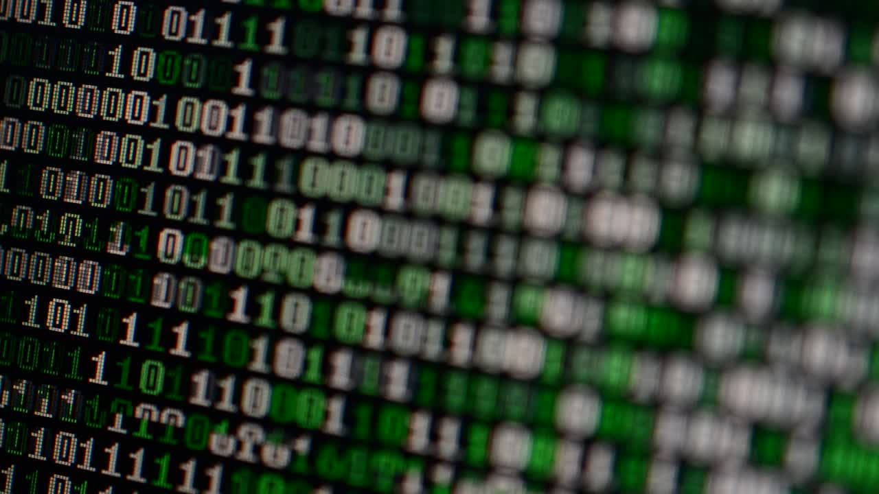 Binary code on the monitor screen. Shooting of a binary code, background