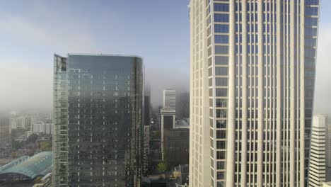 a view of skyscrapers on a foggy early morning in charlotte, nc