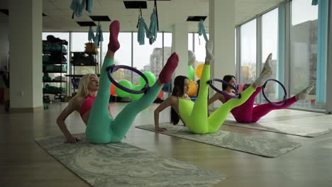 energetic group of women engaging in a lively hula hoop fitness class highlighting flexibility energetic group of women engaging in a lively hula hoop fitness class highlighting flexibility and strength in a welllit modern studio
