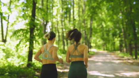 Back-View-Of-Two-Sportswomen-Running-In-The-Woods-4