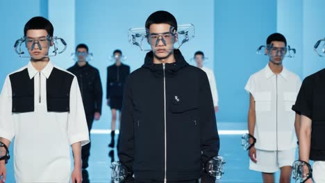 futuristic fashion showcase: a group of models strut down the runway in unique outfits and high-tech accessories, captivating the audience with their avant-garde style