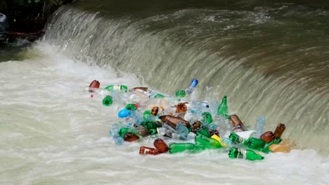 plastic bottles and garbage in a mountain river plastic bottles and garbage in a mountain river the problem of environmental pollution environmental disaster