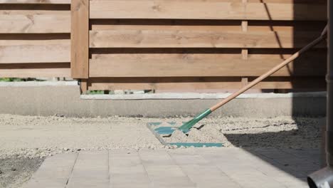 gardener laying a roll of natural lawn turf