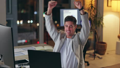 Excited businessman celebrating success at his desk