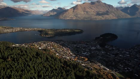 Drone-shot-over-Queenstown-hill-reveal-scenery-of-picturesque-lake-and-majestic-mountains