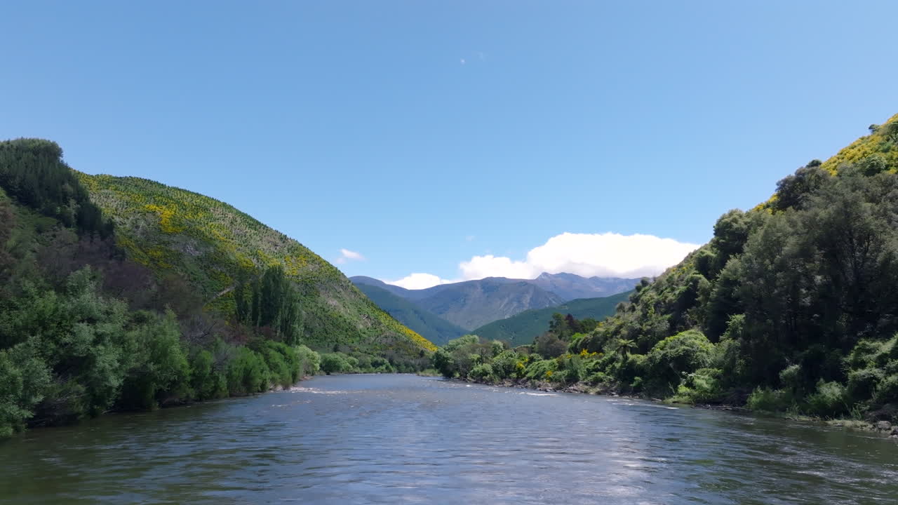 Low flying drone over the surface of the water flying over the Motueka river in New Zealand