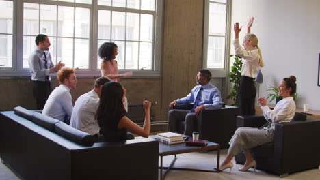 Female-boss-and-colleagues-celebrate-at-a-meeting,-close-up