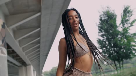 woman dancing under a bridge