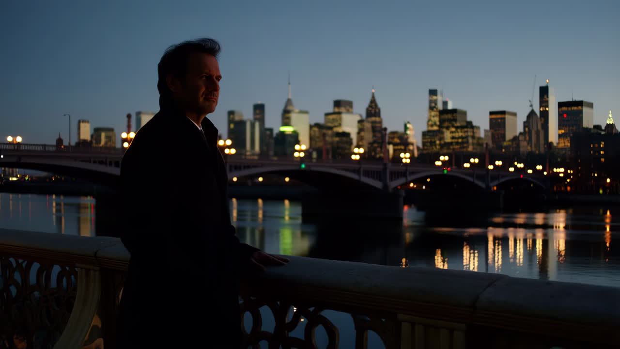 Man gazing at city skyline at night