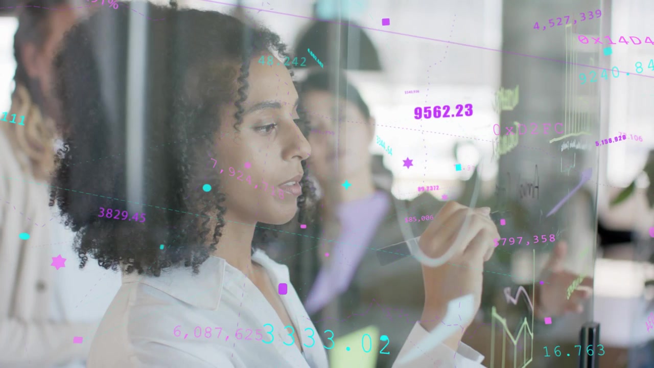 Team lead woman pausing then drawing on glass during business meeting, generating animated graphs