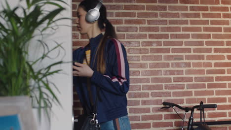 beautiful-young-asian-woman-getting-ready-leaving-apartment-using-smartphone-texting-late-for-work