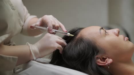 a focused treatment of mesotherapy on the scalp to enhance hair vitality, showcasing the precision and care of the medical practitioner