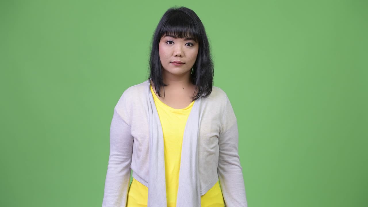 Beautiful happy Asian woman smiling with arms crossed