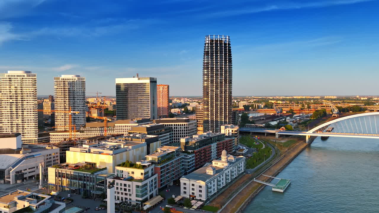 Modern architecture of Bratislava in the sunlight. Footage over the Danube near the Appolo Bridge