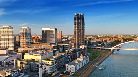 modern architecture of bratislava in the sunlight. footage over the danube near the appolo bridge