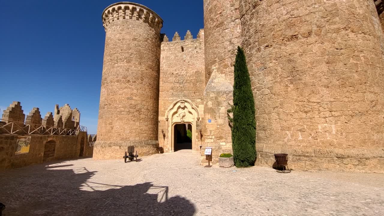 Interior view of medieval castle. Walking towards the entrance to the castle's parade ground. Stone facade and battlements. Middle Ages.