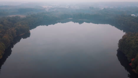 Aerial-of-a-beautiful-foggy-lake-in-a-forest-in-the-morning
