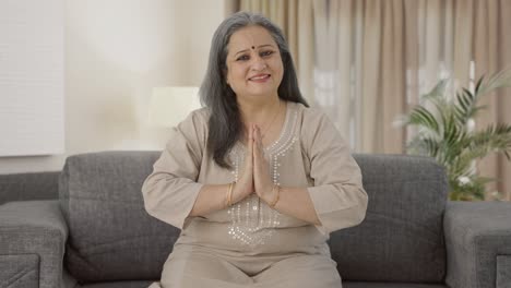 happy indian old woman doing namaste and greeting