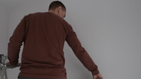 couple hanging wallpaper together