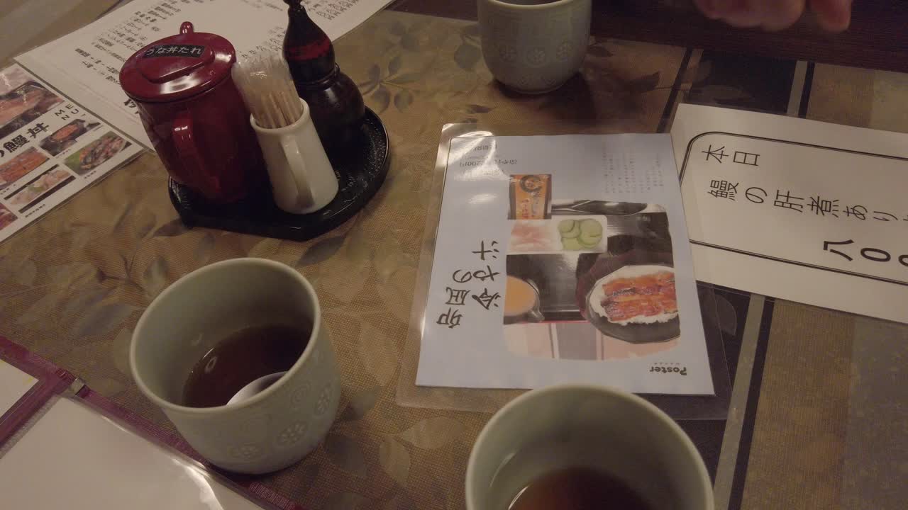 Traditional Table and Menu at Eel Fish Restaurant in Kyoto Japan with Hot Tea