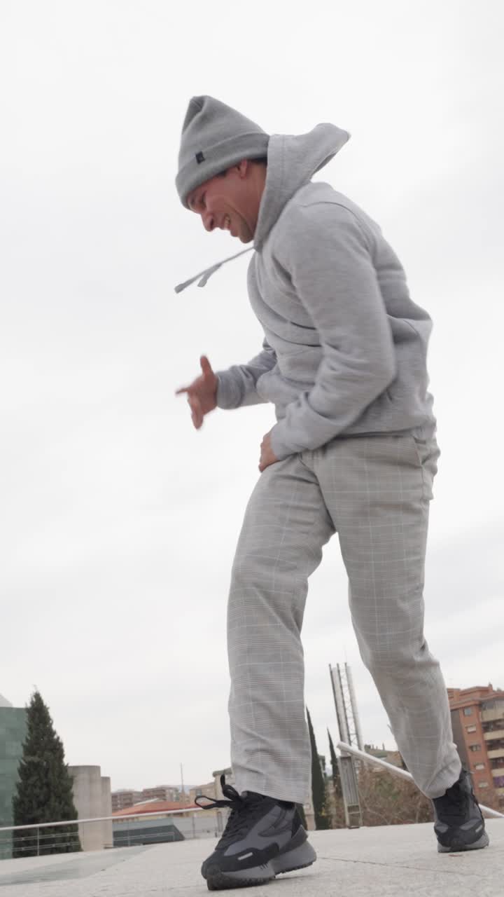 Energetic dancer performing urban freestyle moves outdoors
