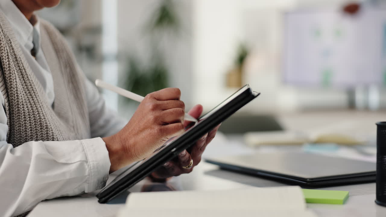 Woman working with tablet and digital pen in office