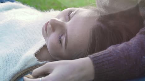 young woman resting on someone's lap