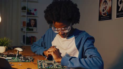 young man repairing a circuit board