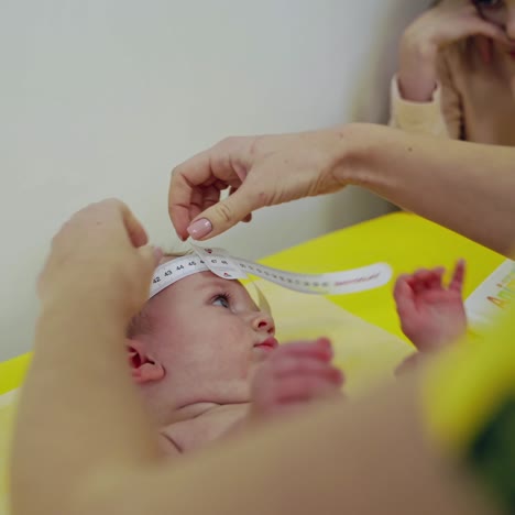female doctor examining child. cute kid girl at medical visiting with mother in the hospital
