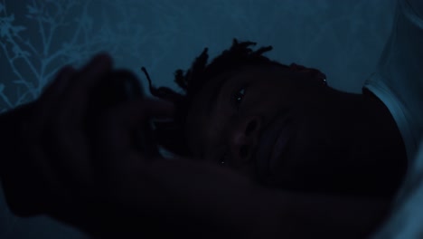 man laying in bed using a smart phone