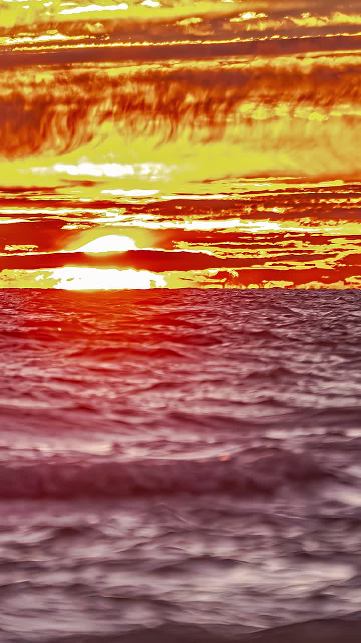Timelapse Of Sunrise Across Fiery Sky Over Ocean - Vertical Shot