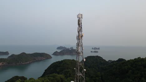 radio telecommunication tower on top of a hill overlooking amazing islands in the bay in cat ba and halong bay in northern vietnam