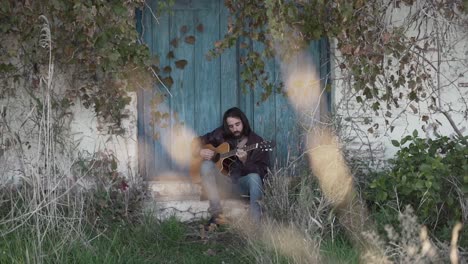 hombre tocando la guitarra acústica al aire libre