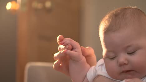 mother holding babys hand 01