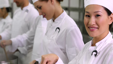 Chef-tossing-vegetables-smiling-at-camera