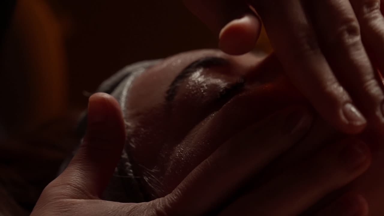 Woman Receiving Relaxing Facial Massage at a Spa