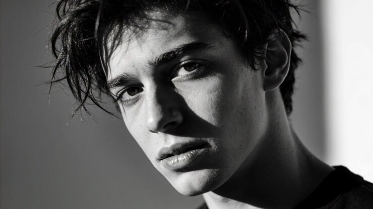 Starting camera male posing head and eye shifting in studio, with right highlight and dark crewneck
